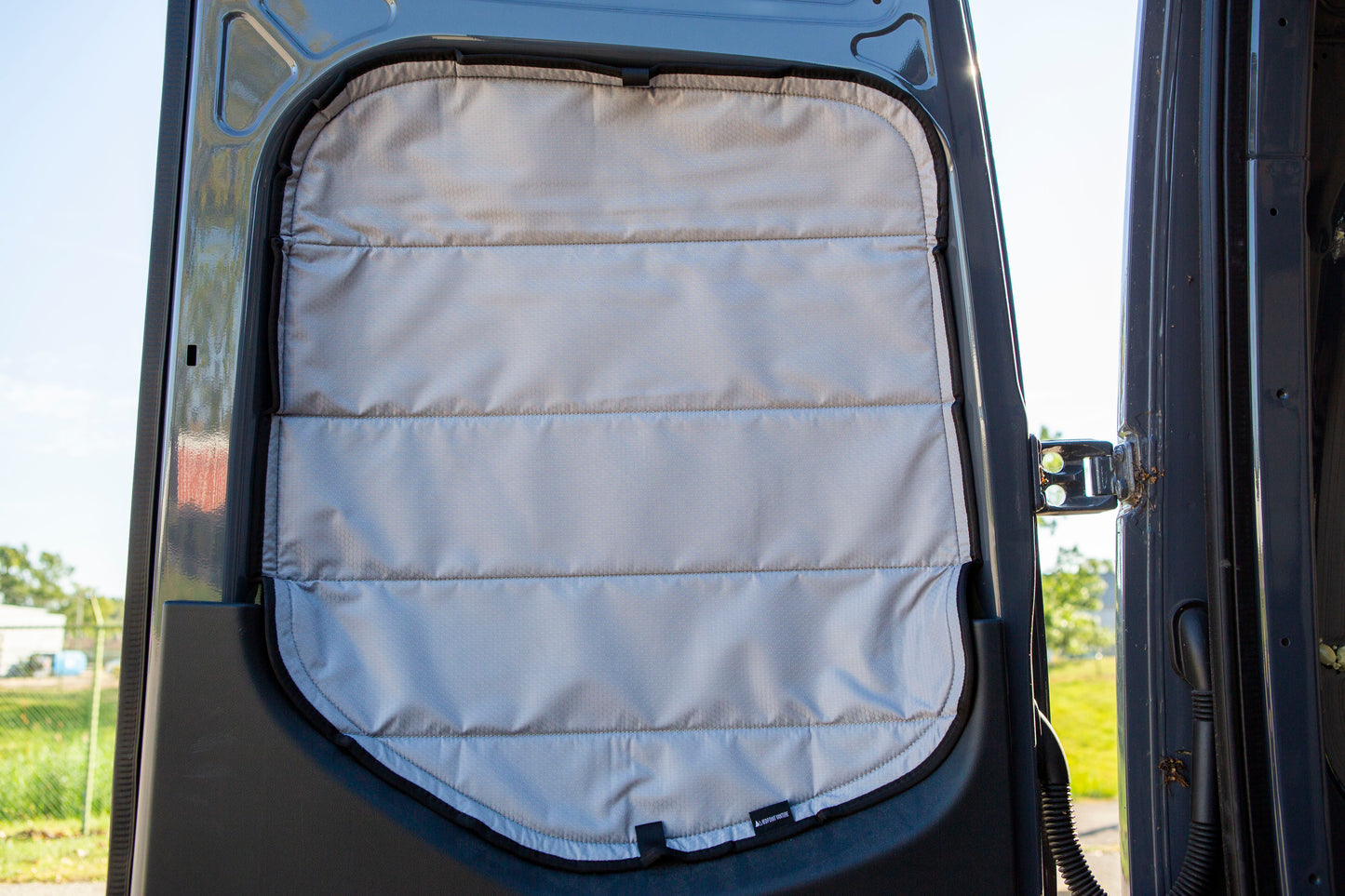 Image of the rear door cover seamlessly attached to the rear window with the rear door opened, showcasing a perfect fit and sleek installation.