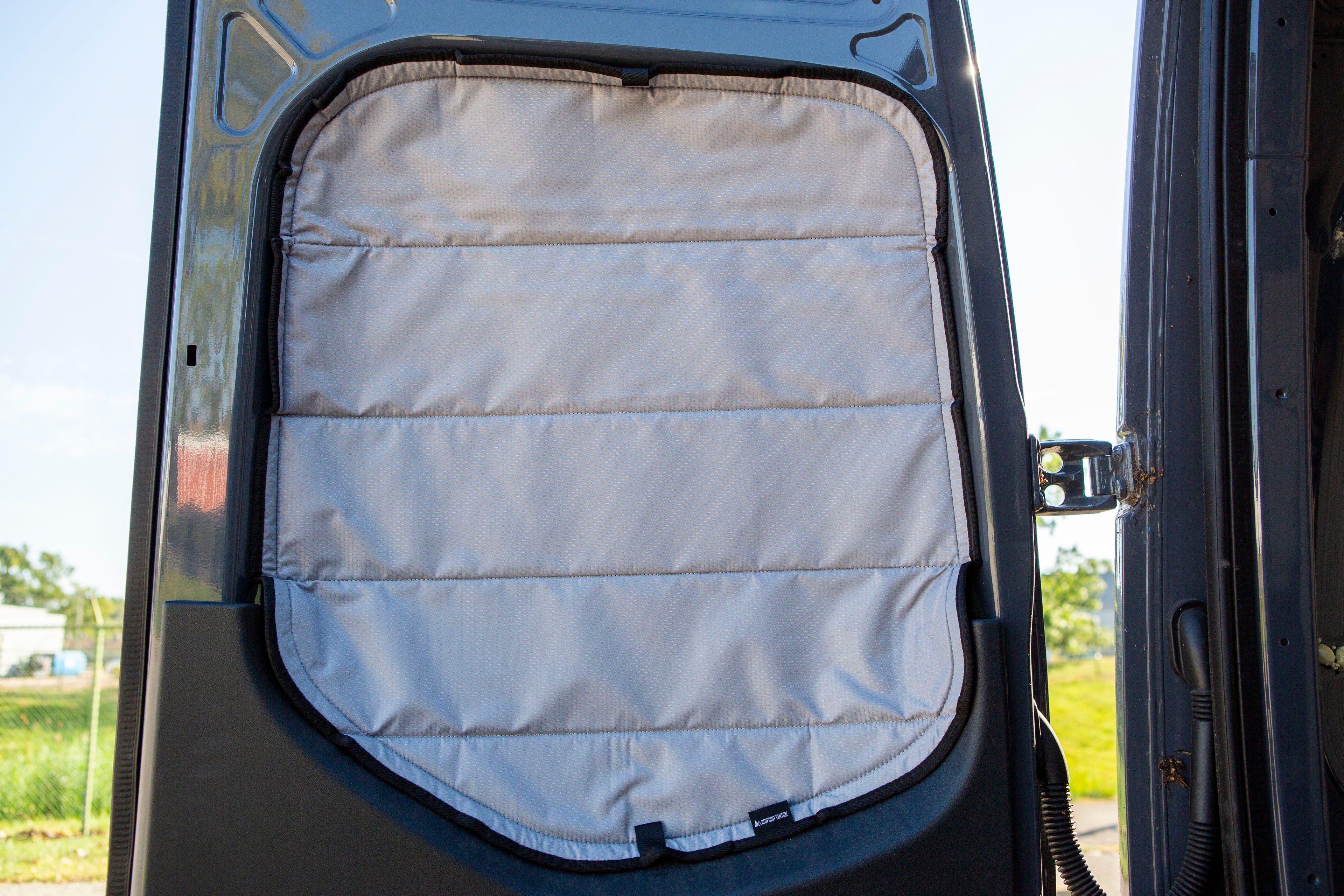 Image of the rear door cover seamlessly attached to the rear window with the rear door opened, showcasing a perfect fit and sleek installation.
