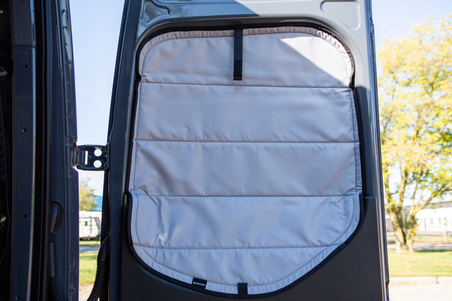 Image of the rear door cover seamlessly attached to the rear window with the rear door opened, showcasing a perfect fit and sleek installation.