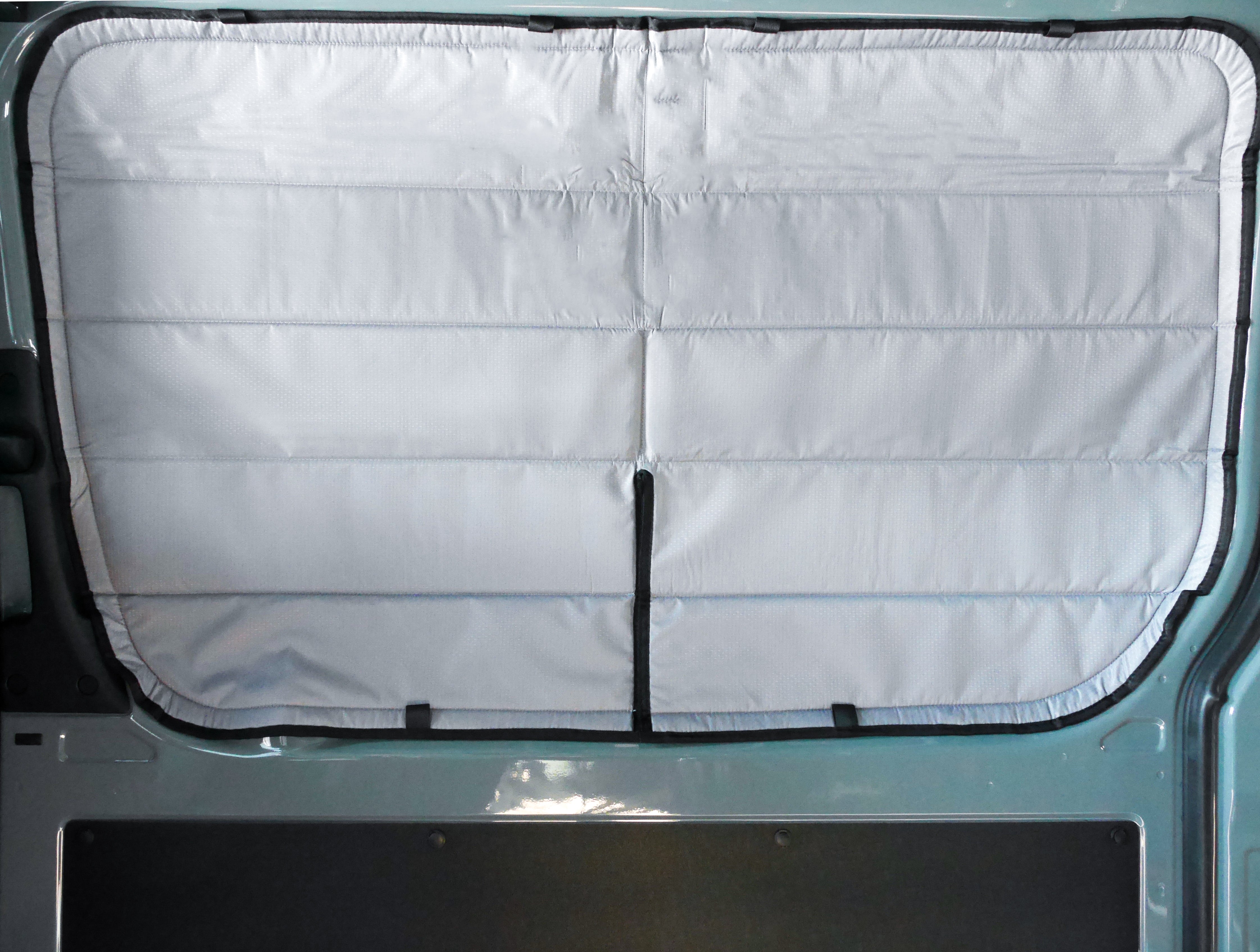 Image of the cover seamlessly attached to a sliding door window in a Sprinter van, showcasing a perfect fit and sleek installation.