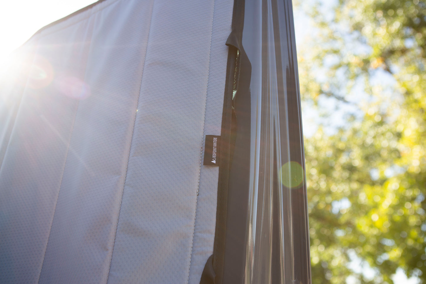 Close-up image of the Redpoint Van Parts logo tag on the window cover, highlighting its high-quality material and precise design for a secure, seamless fit on the window.