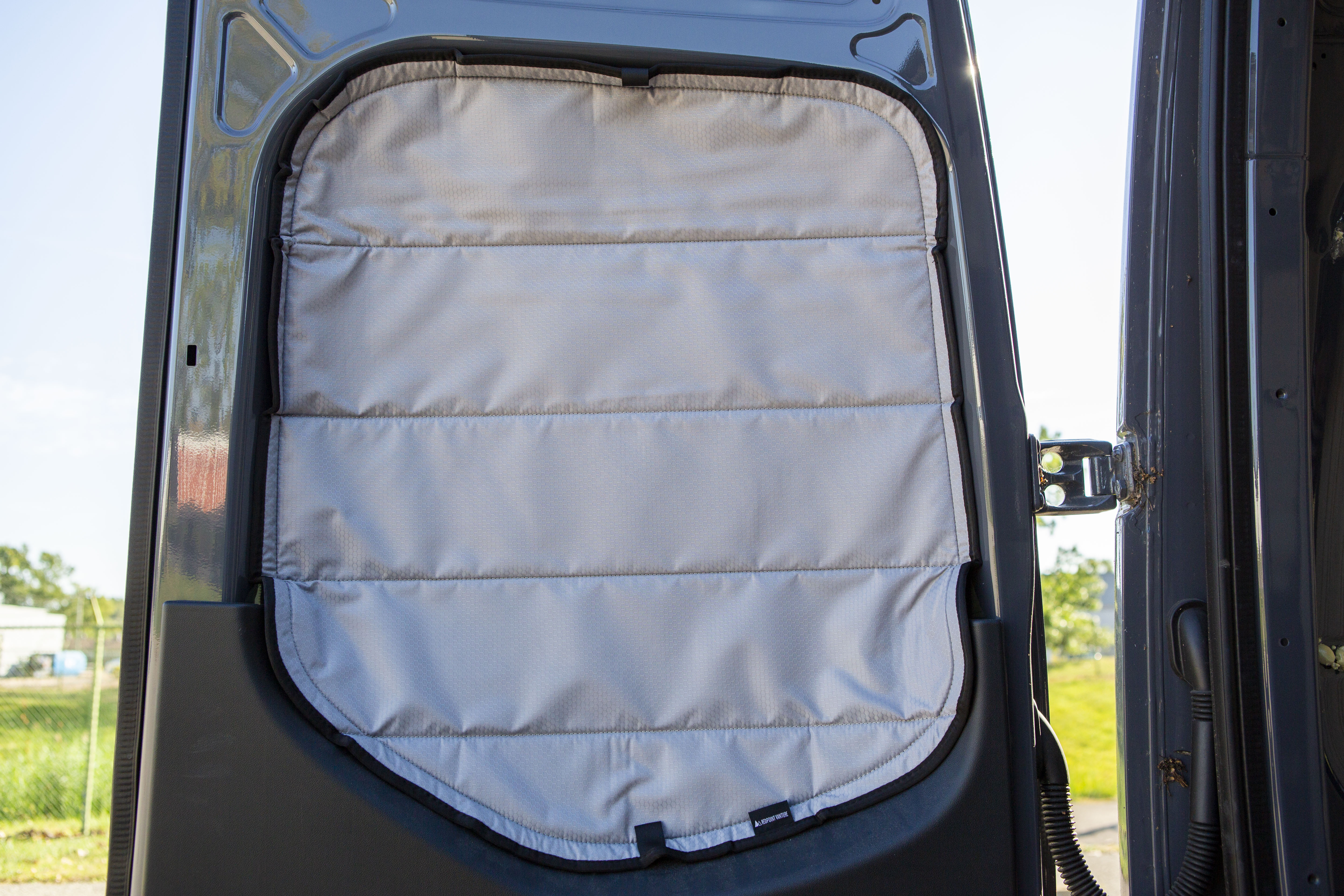 Image of the rear door cover seamlessly attached to the rear window with the rear door opened, showcasing a perfect fit and sleek installation.